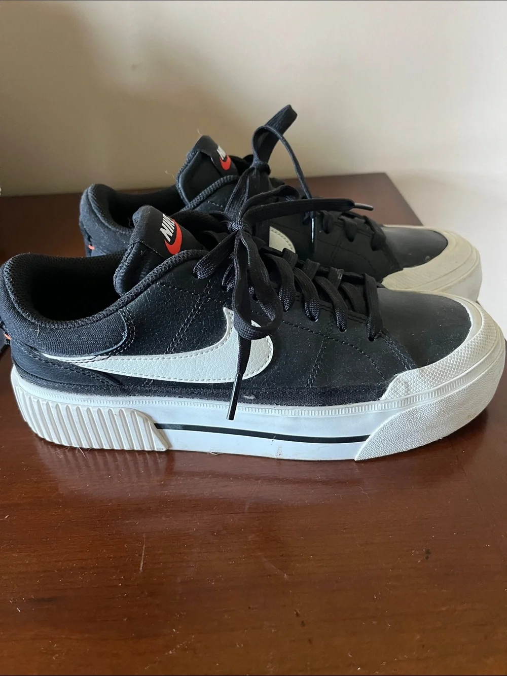 Nike Women’s Black Sneakers with White Swoosh and Red Tongue Logo